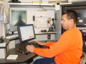 A TV sewer inspection operator is shown at a computer.